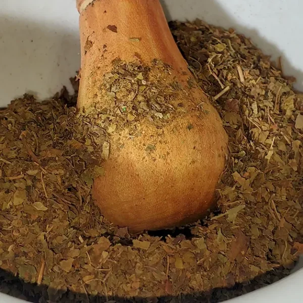 Red Crushed Leaf Kratom, Raw Leaf Batch 15561, displayed in a bowl, showcasing the vibrant color and texture of the leaves.