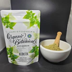 White Maeng Da kratom powder, batch 150632, in a sealed opaque package with a labeled front, resting on a plain surface.