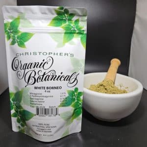 White Borneo kratom powder, batch 151905, in a sealed non-transparent package labeled with batch details, placed on a clean surface.