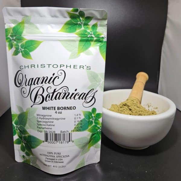 White Borneo kratom powder, batch 151905, in a sealed non-transparent package labeled with batch details, placed on a clean surface.